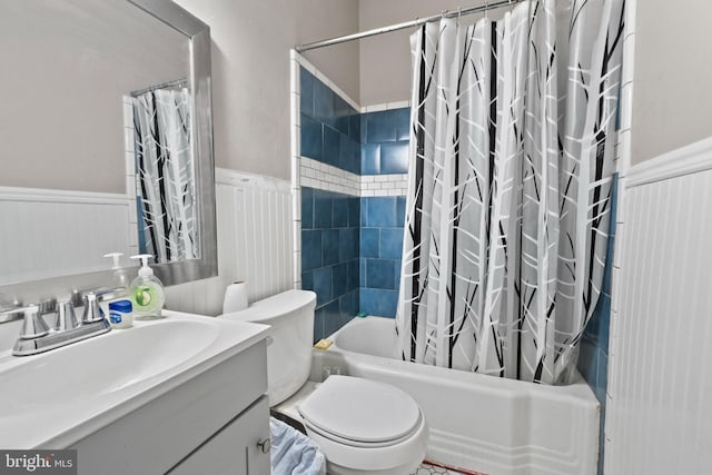 full bath with vanity, toilet, wainscoting, and shower / bath combination with curtain