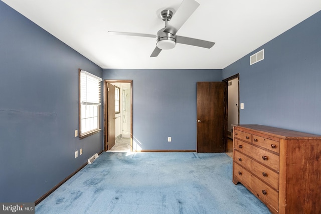 unfurnished bedroom featuring visible vents, light carpet, ensuite bathroom, a ceiling fan, and baseboards