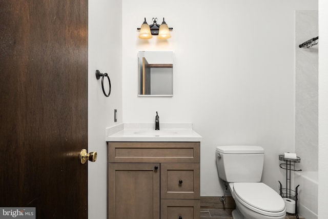 bathroom featuring vanity, toilet, and wood finished floors