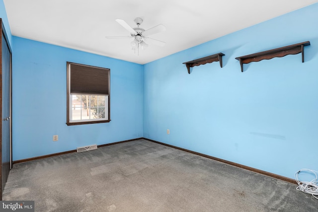 empty room with visible vents, baseboards, ceiling fan, and carpet floors