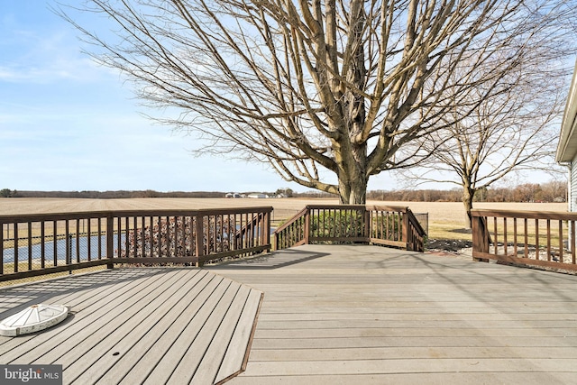 wooden terrace featuring a rural view