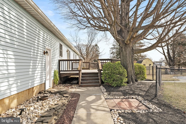 view of yard with a deck and fence