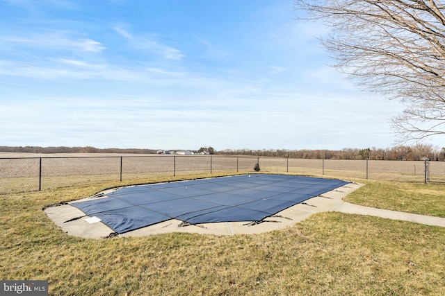 view of swimming pool with a fenced in pool, fence, and a lawn