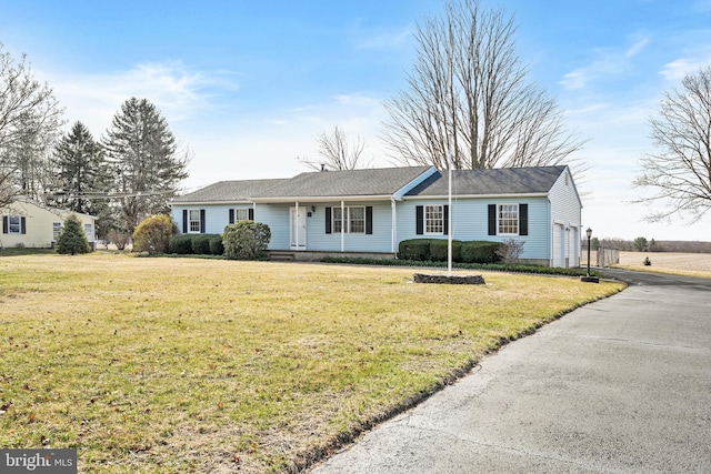 ranch-style home with a garage, driveway, and a front yard