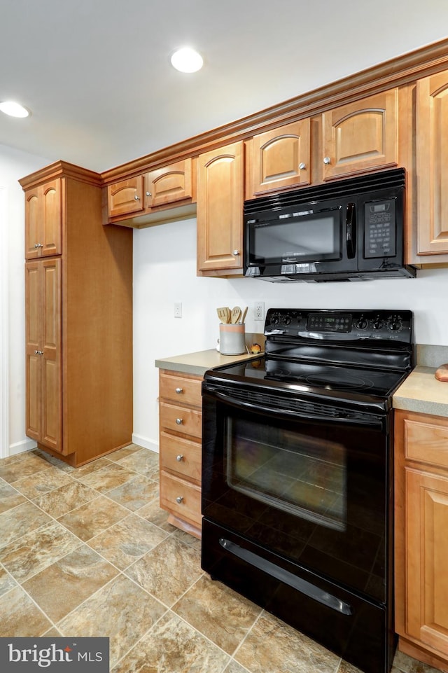 kitchen featuring recessed lighting, black appliances, light countertops, and brown cabinets