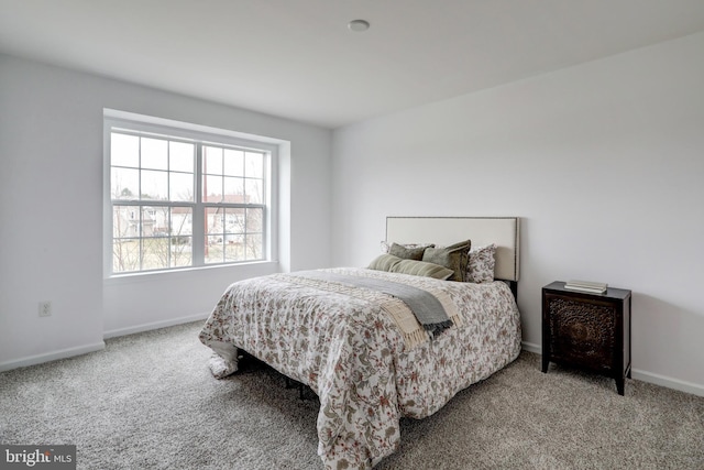 bedroom featuring baseboards and carpet