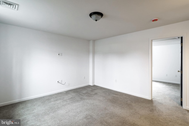 carpeted spare room with baseboards and visible vents