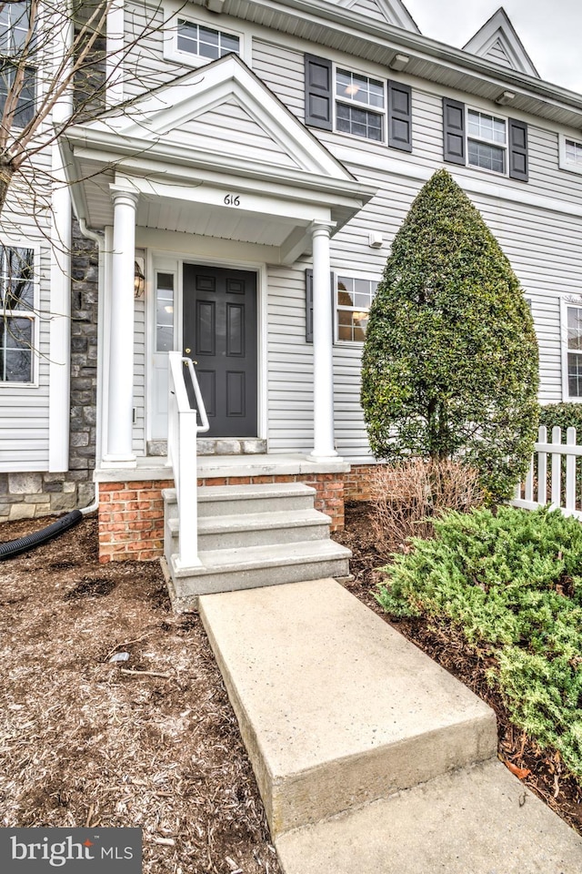 view of exterior entry with fence