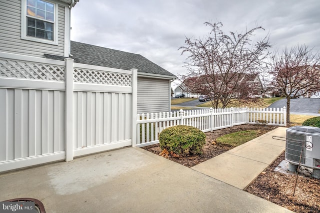 view of patio / terrace with cooling unit and fence