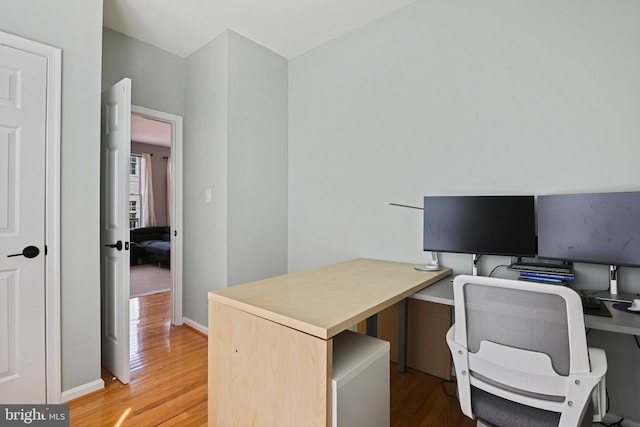 office with baseboards and light wood finished floors