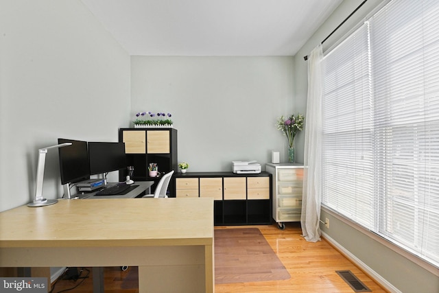 office with visible vents, baseboards, and light wood-style floors