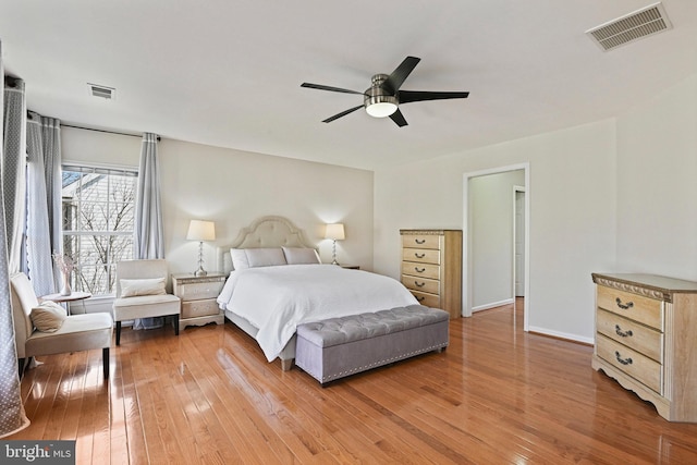 bedroom with visible vents, baseboards, and hardwood / wood-style floors