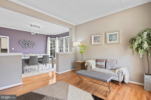 sitting room featuring crown molding, wood finished floors, and baseboards