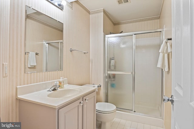 bathroom with tile patterned flooring, toilet, a shower stall, and wallpapered walls