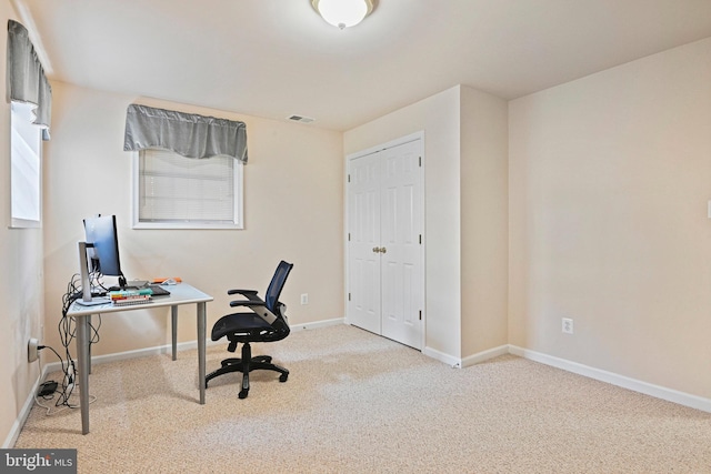 carpeted office featuring visible vents and baseboards