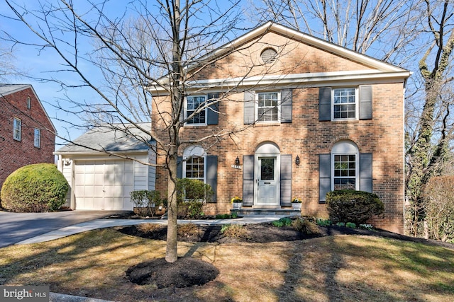 view of front of property featuring concrete driveway, an attached garage, and brick siding