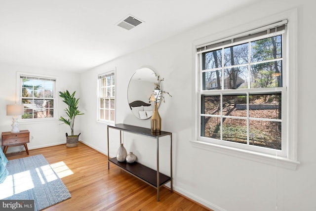 sitting room featuring wood finished floors, visible vents, and baseboards