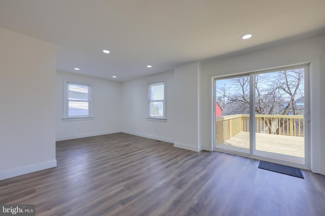 unfurnished room with recessed lighting, baseboards, and wood finished floors