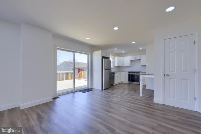 kitchen featuring recessed lighting, stainless steel appliances, dark wood finished floors, and white cabinetry