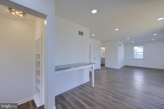 unfurnished room featuring recessed lighting, dark wood-style floors, and visible vents