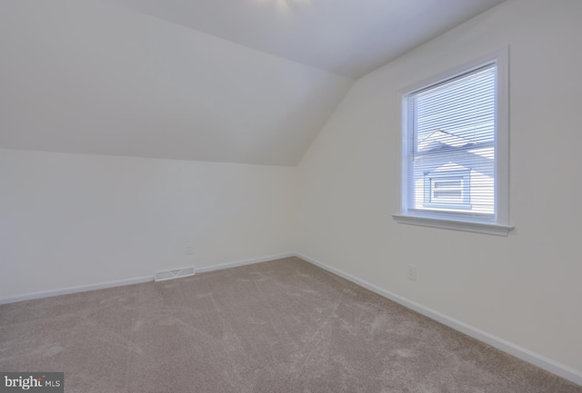 bonus room featuring visible vents, baseboards, carpet flooring, and vaulted ceiling