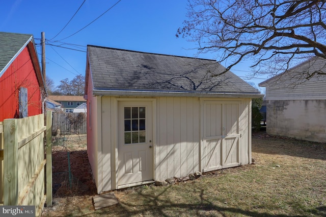 view of shed featuring fence