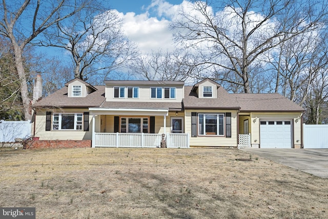 view of front of home with covered porch, a shingled roof, a garage, and fence