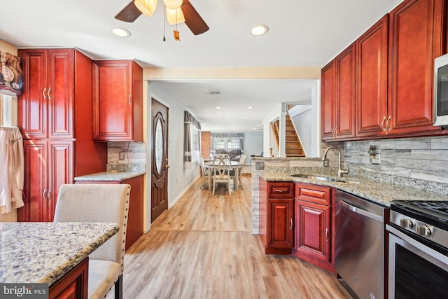 kitchen featuring a sink, dark brown cabinets, and stainless steel appliances