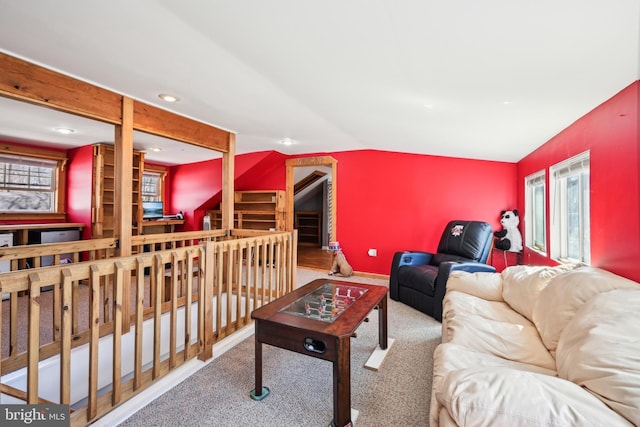 carpeted living area featuring recessed lighting, baseboards, and lofted ceiling