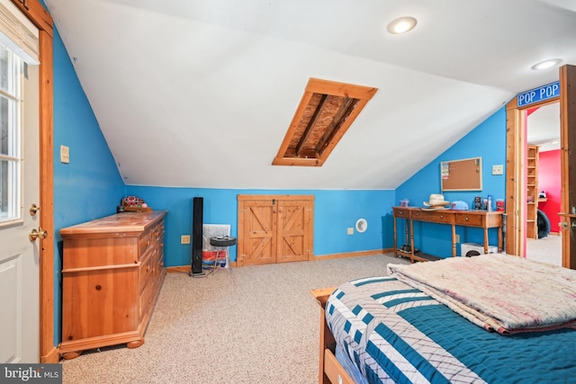 bedroom with vaulted ceiling with skylight, carpet, and baseboards