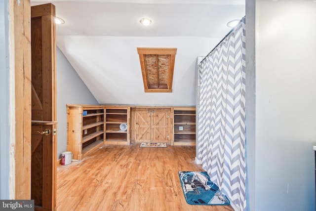 bonus room featuring lofted ceiling and light wood finished floors