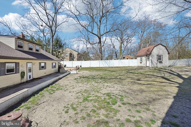 view of yard with a fenced backyard and an outdoor structure