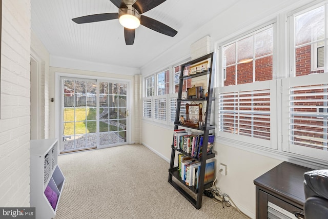 sunroom featuring a ceiling fan