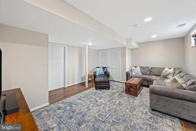 living area with recessed lighting, visible vents, baseboards, and wood finished floors