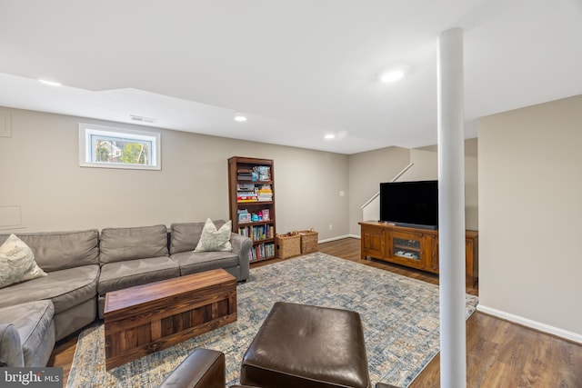 living room with recessed lighting, visible vents, baseboards, and wood finished floors