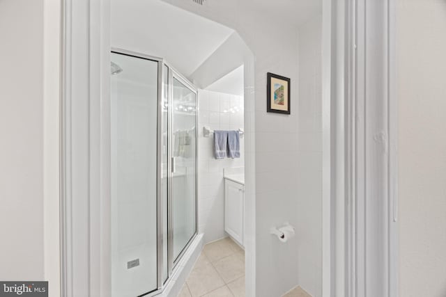 bathroom featuring tile patterned floors and a shower stall