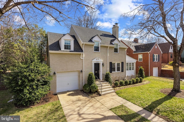 traditional-style home with a shingled roof, concrete driveway, a front lawn, a garage, and brick siding