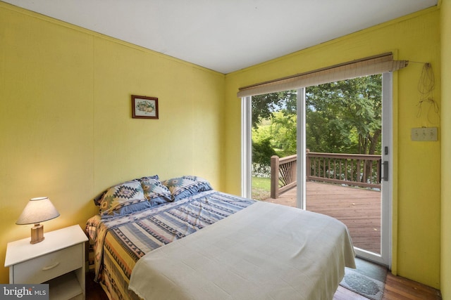 bedroom featuring wood finished floors and access to exterior