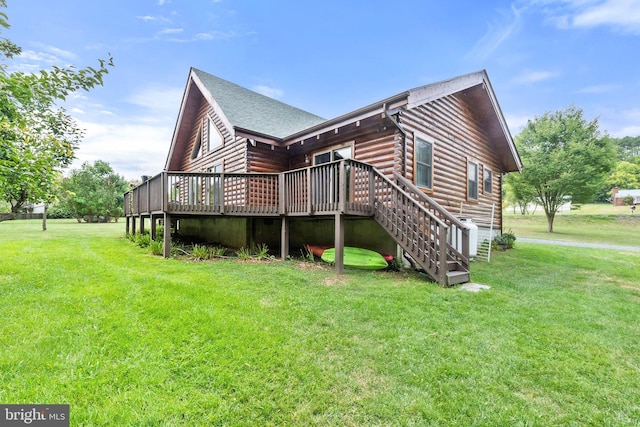 view of home's exterior featuring stairway, a lawn, a deck, and a shingled roof