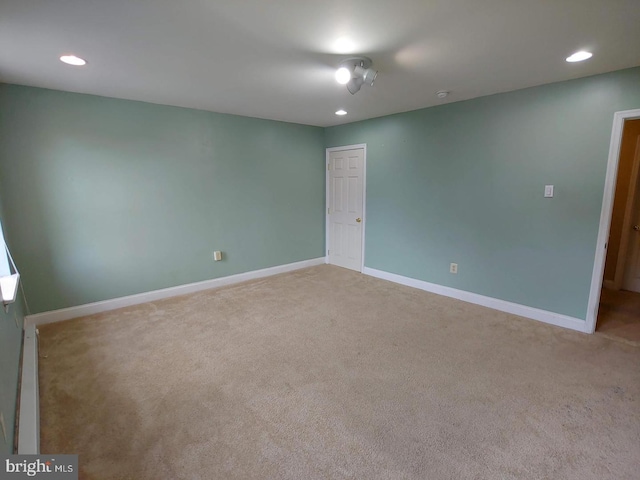 carpeted empty room featuring recessed lighting and baseboards