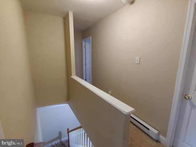 corridor with an upstairs landing and baseboard heating