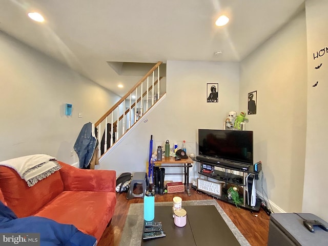 living room featuring recessed lighting, stairway, baseboards, and wood finished floors