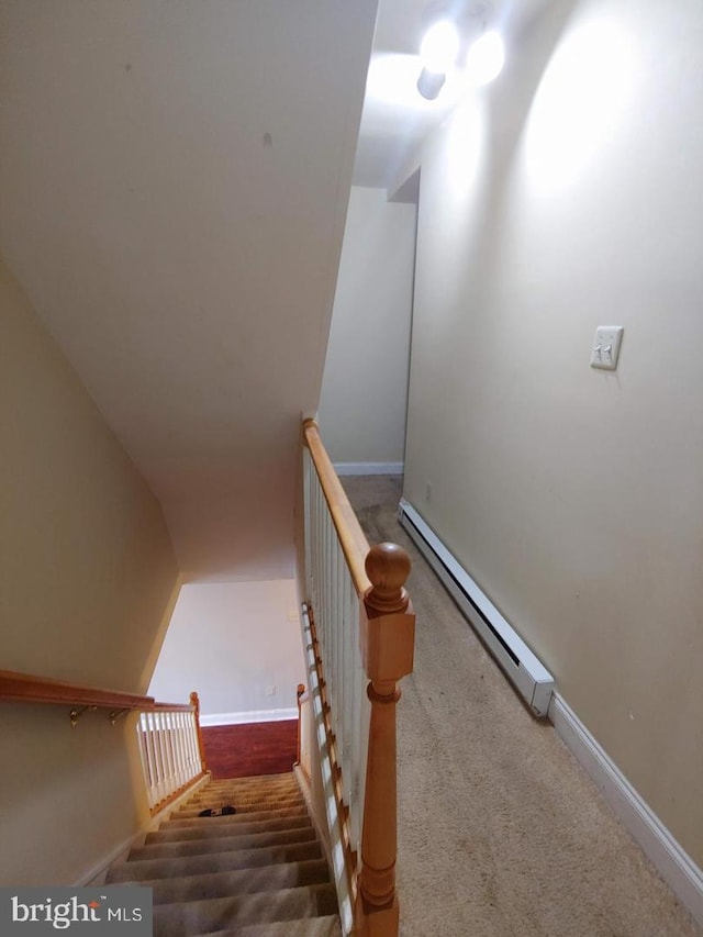 stairs featuring baseboards and a baseboard radiator