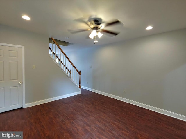 unfurnished room featuring stairway, recessed lighting, baseboards, and dark wood-style flooring