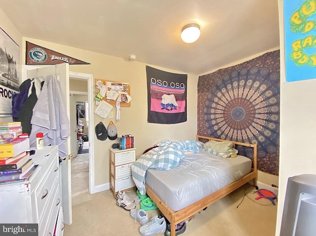 bedroom featuring carpet flooring and baseboards