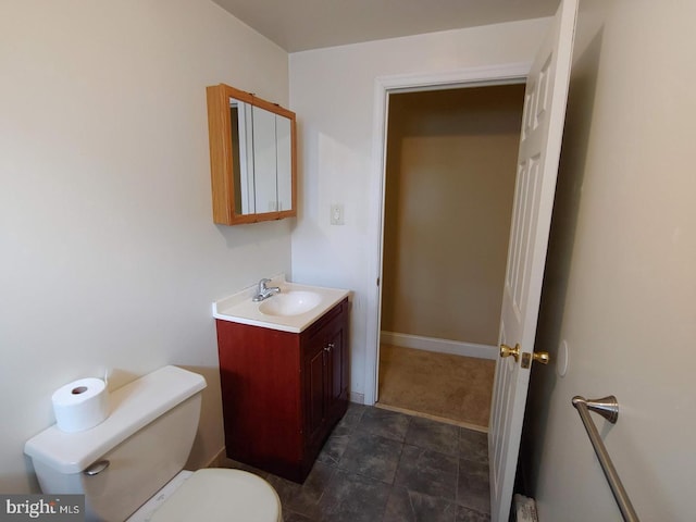 bathroom featuring toilet and vanity