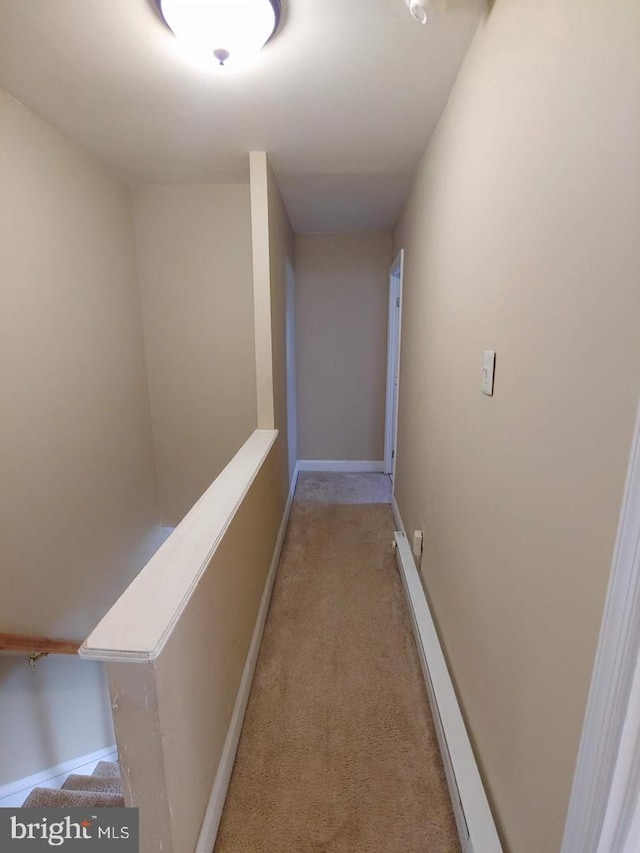 corridor with light colored carpet and baseboards