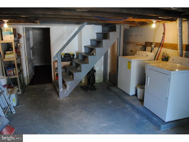 unfinished basement with washing machine and dryer and stairs