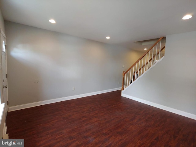 interior space featuring recessed lighting, stairs, baseboards, and wood finished floors