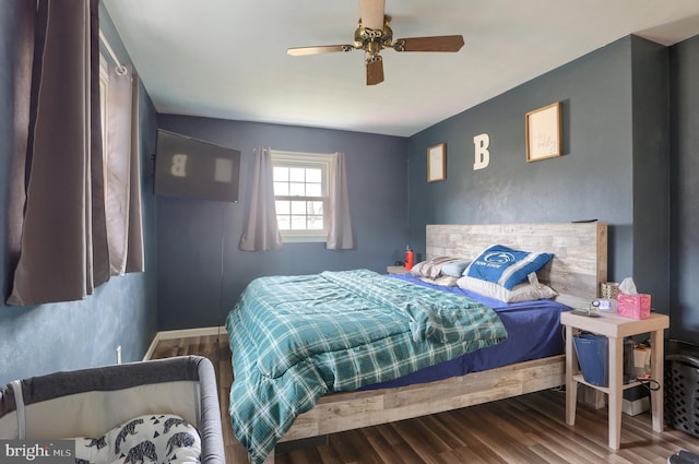 bedroom with wood finished floors, baseboards, and ceiling fan